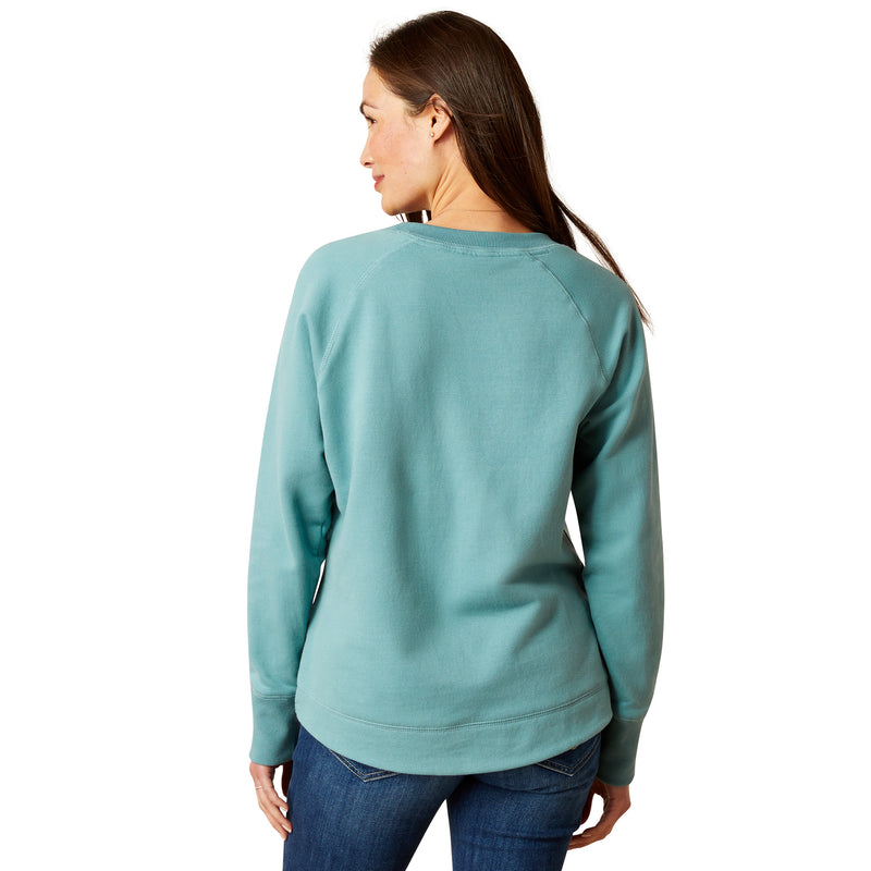 An image of a female model wearing the Ariat Benicia Sweatshirt in the colour Arctic.