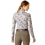 An image of a female model wearing the Ariat Lowell Wrap Baselayer in the colour Equine Floral.