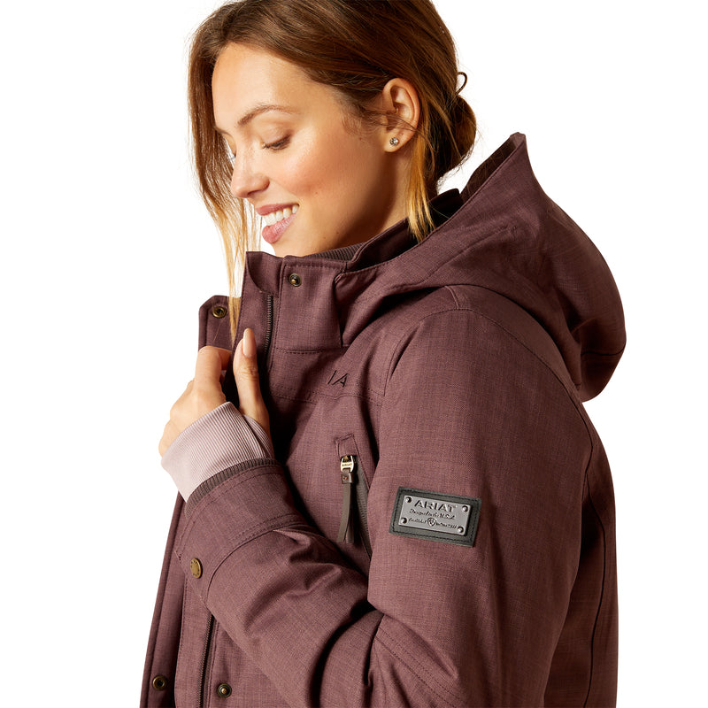 An image of a female model wearing the Ariat Sterling Waterproof Insulated Parka in the colour Raisin Pink.