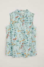 Seasalt Flower Fields Vest. An A-line sleeveless top with high frilled collar, button placket, and blue floral print.