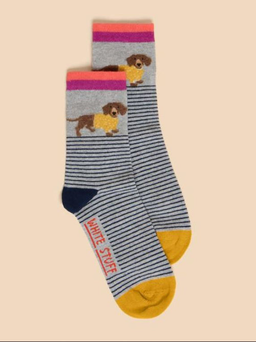 White Stuff Fluffy Sausage Dog Sock with striped design, yellow toe, navy heel and a cute sausage dog on the side.