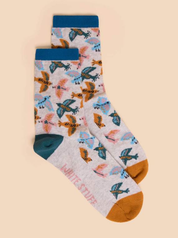 White Stuff Flying Bird Sock. A cream sock with a colourful flying bird design all-over, a mustard toe, and navy heel.