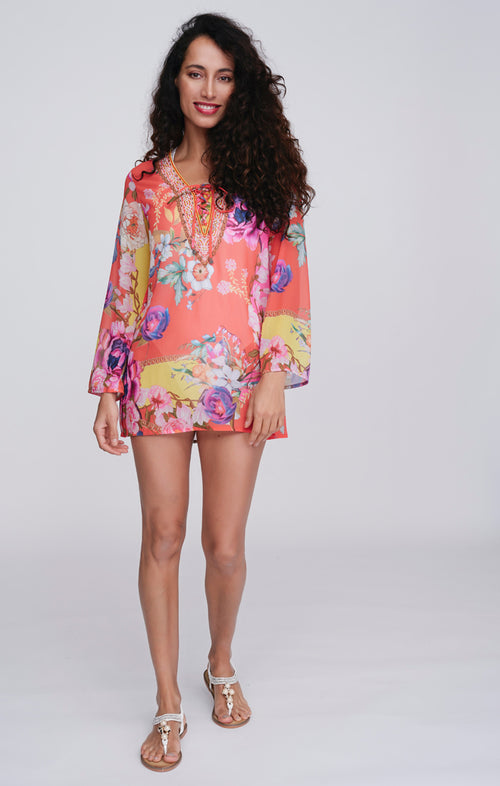 Pia Rossini Hawaii Cover Up. A midi-length, long sleeve cover up in a lightweight material, with V-neckline, dazzling embellishment and pink floral print.
