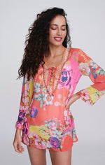 Pia Rossini Hawaii Cover Up. A midi-length, long sleeve cover up in a lightweight material, with V-neckline, dazzling embellishment and pink floral print.