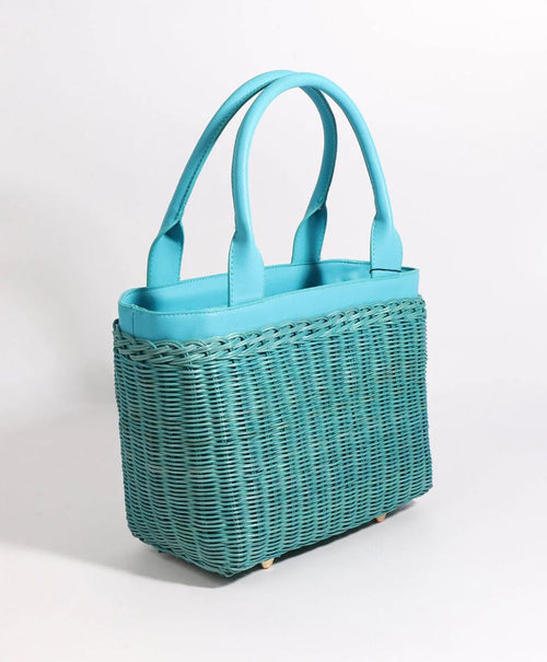 Pia Rossini Juno Bag. A bag made from rattan material with twin top handles and zip closure in a turquoise colour. This bag has a fully lined interior and pockets.
