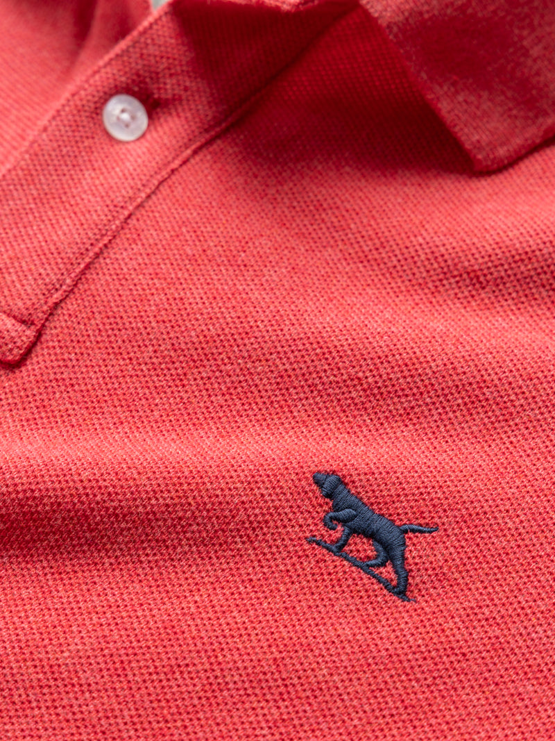 Rodd & Gunn Gunn Polo. A sports fit polo with short sleeves and collared neckline, this polo features a logo on the chest and is a fuchsia colour.