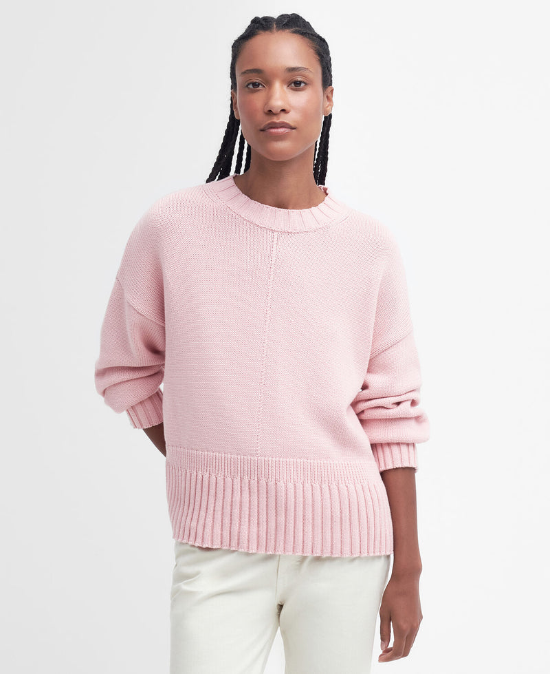 An image of a female model wearing the Barbour Clifton Crew Neck Knitted Jumper in the colour Shell Pink.