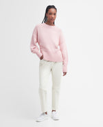 An image of a female model wearing the Barbour Clifton Crew Neck Knitted Jumper in the colour Shell Pink.