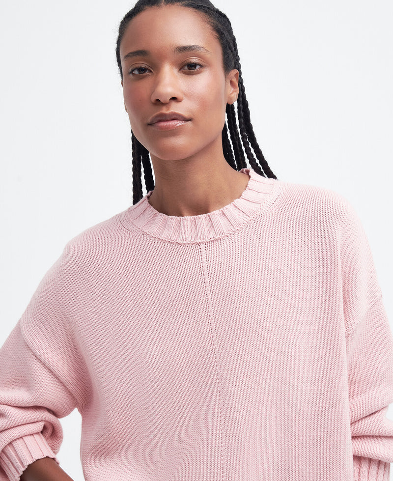 An image of a female model wearing the Barbour Clifton Crew Neck Knitted Jumper in the colour Shell Pink.