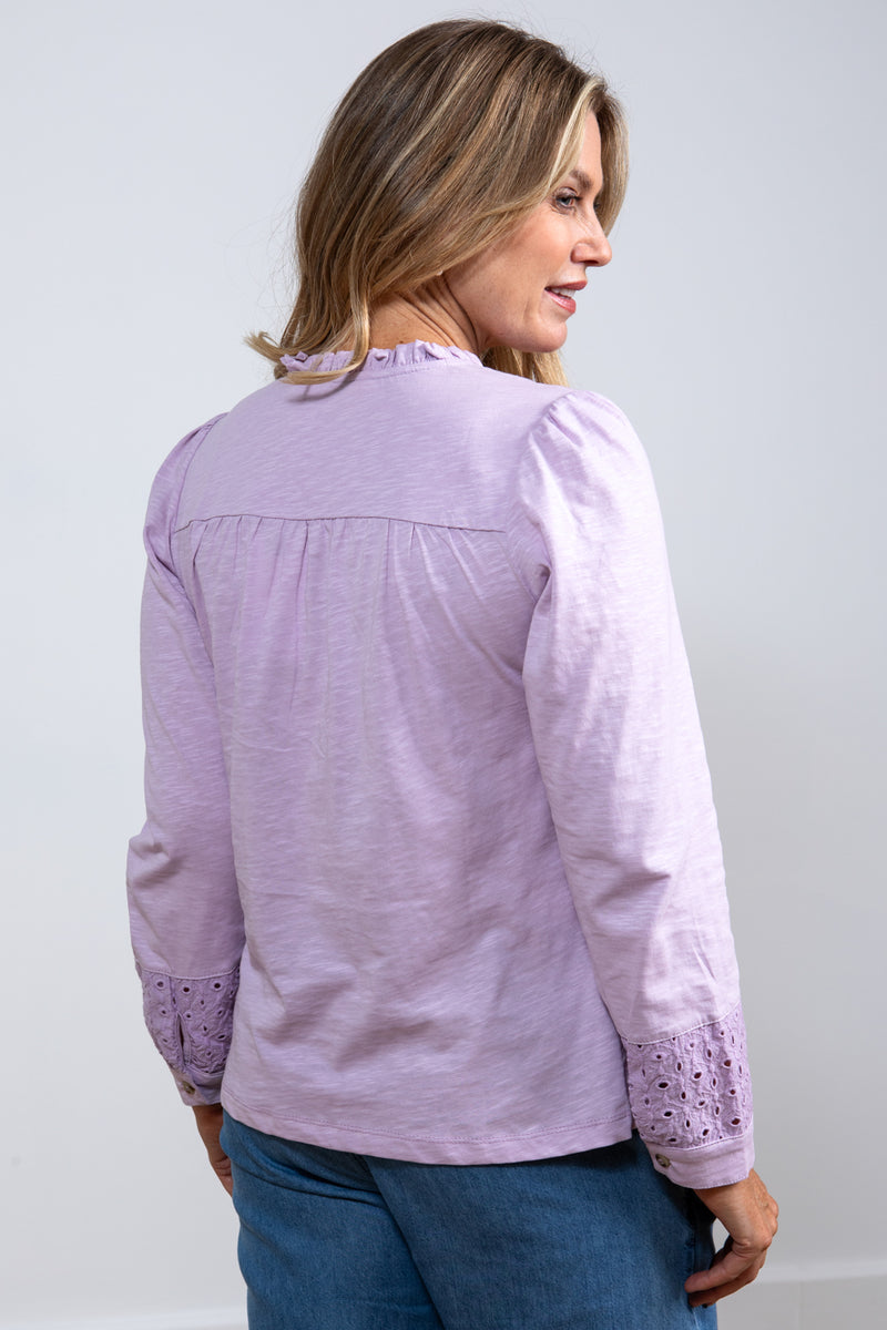 Lily & Me Spring Berkeley Top. A long sleeve, relaxed-fit top with V-neckline, neck ties and lace detail. This top is a lavender purple colour.