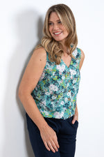 Lily & Me Allium Vest Meadow Spray. A sleeveless, V-neck top with button fastenings and sea green floral print.