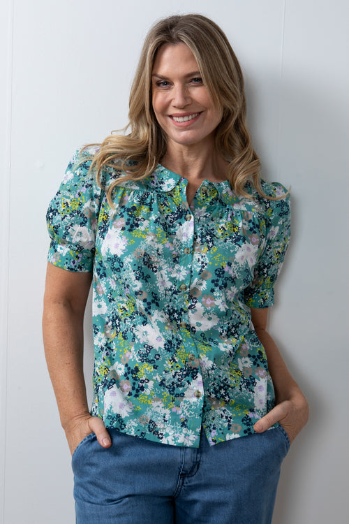 Lily & Me Lily Top Meadow Spray. A semi-relaxed fit top with capped sleeves and round neckline in a sea green floral print.