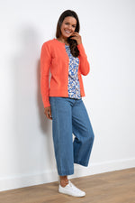 Lily & Me Camellia Cardi. A long sleeve, round neck cardigan with button closure, in sunset orange.