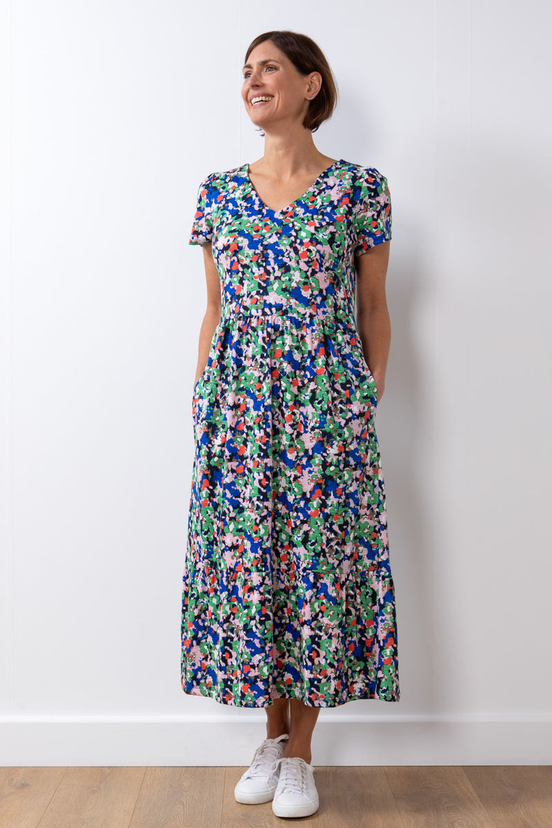 Lily & Me Spring Midi Frieda Dress. A cap-sleeved dress with a v-neck, a flowy tiered skirt, feminine gathered detail at the shoulders, and a bright, colourful design.