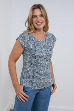 Lily & Me Surfside Tee Dapple. A curved hem t-shirt with short sleeves, a round neckline, and a unique navy linework print.