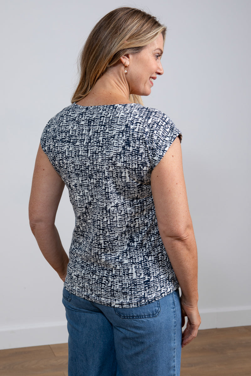 Lily & Me Surfside Tee Dapple. A curved hem t-shirt with short sleeves, a round neckline, and a unique navy linework print.