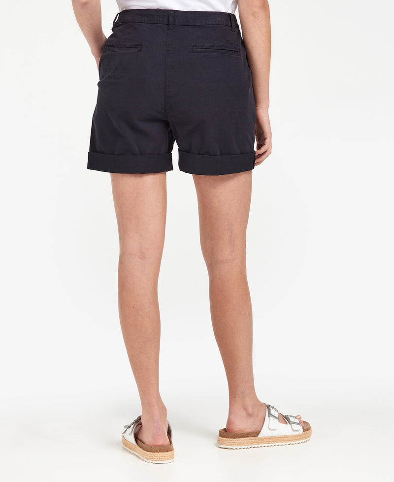 An image of a female model wearing the Barbour Chino Shorts in the colour Navy