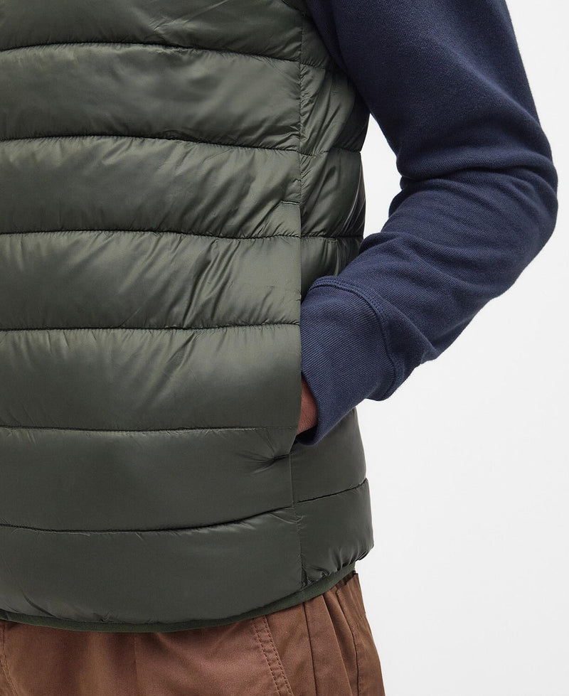 An image of a male model wearing the Barbour Men's Bretby Gilet in the colour Olive.