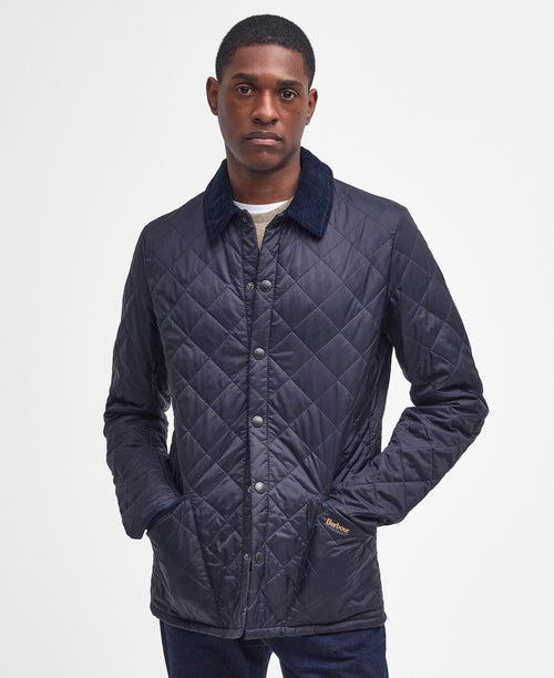 An image of a male model wearing the Barbour Heritage Liddesdale Quilted Jacket in the colour Navy.