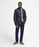 An image of a male model wearing the Barbour Heritage Liddesdale Quilted Jacket in the colour Navy.