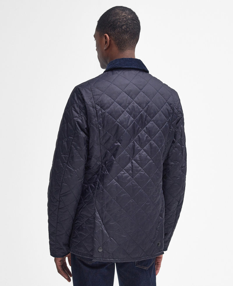 An image of a male model wearing the Barbour Heritage Liddesdale Quilted Jacket in the colour Navy.
