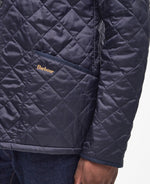 An image of a male model wearing the Barbour Heritage Liddesdale Quilted Jacket in the colour Navy.