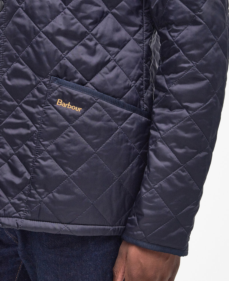 An image of a male model wearing the Barbour Heritage Liddesdale Quilted Jacket in the colour Navy.