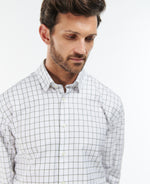 An image of a male model wearing the Barbour Hanstead Country Active Long-Sleeved Shirt in the colour Mid Olive.