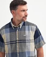 An image of a male model wearing the Barbour Douglas Regular Short-Sleeved Shirt in the colour River Birch.