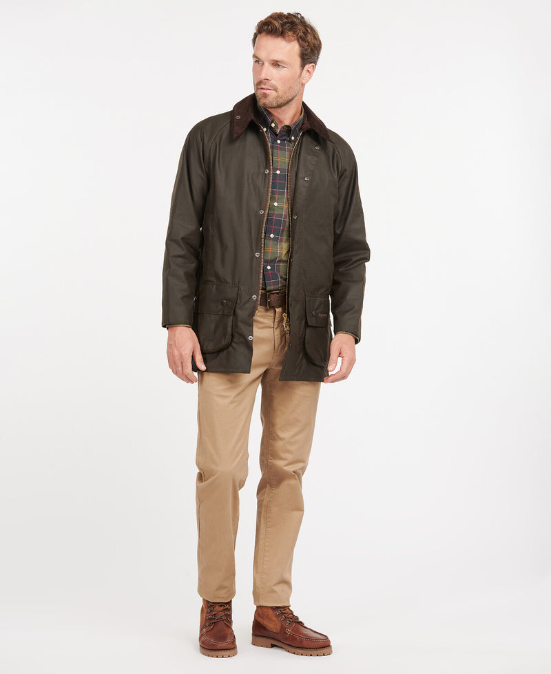 An image of a male model wearing the Barbour Classic Beaufort Wax Jacket in the colour Olive.