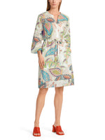 Marc Cain Tie Waist Dress. A casual wide fit dress with wide sleeves, round neck and tie waist. This dress is knee length and features a multicoloured eye-catching print.