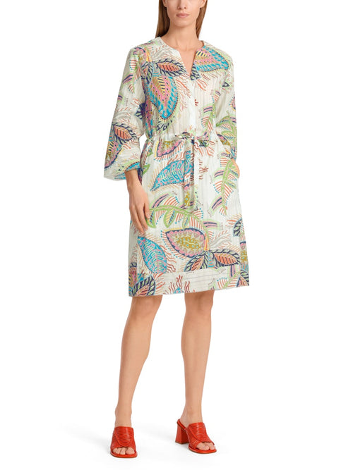 Marc Cain Tie Waist Dress. A casual wide fit dress with wide sleeves, round neck and tie waist. This dress is knee length and features a multicoloured eye-catching print.