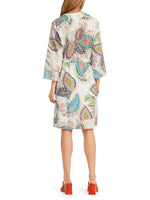 Marc Cain Tie Waist Dress. A casual wide fit dress with wide sleeves, round neck and tie waist. This dress is knee length and features a multicoloured eye-catching print.