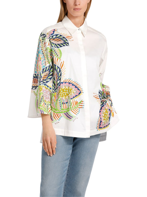 Marc Cain Beaded Floral Blouse. An A-line blouse with wide sleeves and kent style collar. This shirt has a multicoloured print with embroidery and a side seam slit.