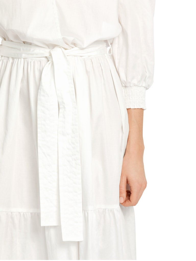Marc Cain Tiered Maxi Dress. A maxi length dress with 3/4 length sleeves, tiered skirt and kent style collar. This dress is off-white and has a tie waist detail.