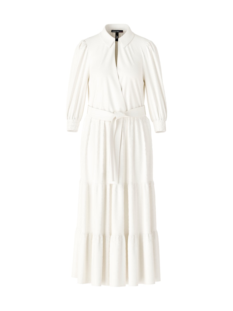 Marc Cain Tiered Maxi Dress. A maxi length dress with 3/4 length sleeves, tiered skirt and kent style collar. This dress is off-white and has a tie waist detail.