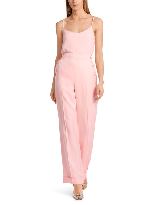 Marc Cain Wide Leg Wheaton Trousers. A wide leg, straight fit trouser with trimmed buttons, pockets and turn up hem. These trousers have a zip fastening and are a soft pink colour.