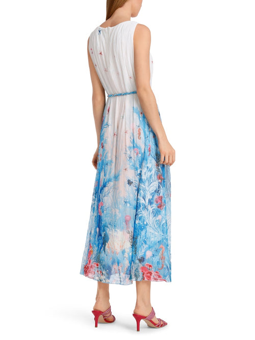 Marc Cain Sleeveless Pleated Dress. A maxi length, sleeveless dress with tie belt and back zip. This dress is white, featuring a blue and red underwater print.