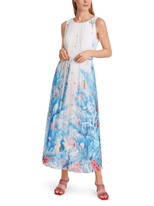 Marc Cain Sleeveless Pleated Dress. A maxi length, sleeveless dress with tie belt and back zip. This dress is white, featuring a blue and red underwater print.