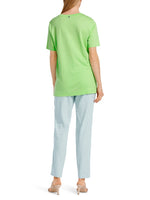 Marc Cain Short Sleeve V-Neck Top. A loose cut T-shirt with short sleeves, V-neck, and side slits, in an eye-catching green colour.