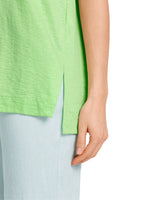 Marc Cain Short Sleeve V-Neck Top. A loose cut T-shirt with short sleeves, V-neck, and side slits, in an eye-catching green colour.