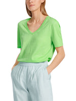 Marc Cain Short Sleeve V-Neck Top. A loose cut T-shirt with short sleeves, V-neck, and side slits, in an eye-catching green colour.