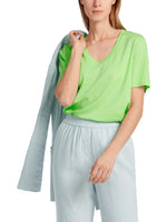 Marc Cain Short Sleeve V-Neck Top. A loose cut T-shirt with short sleeves, V-neck, and side slits, in an eye-catching green colour.