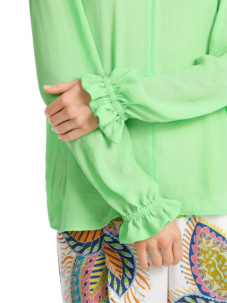 Marc Cain Blouse. An A-line blouse with long ham sleeves and tie neck detail. This blouse is light and airy and the colour is vibrant green.