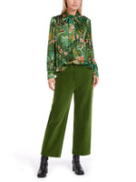 Marc Cain Pussy Bow Blouse with green floral print and long sleeves - full body model image with green trouser and black boots