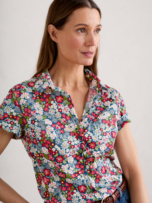 An image of a model wearing the Seasalt Mrs Treloar Short Sleeve Shirt in the colour Flowery Painting Light Squid.