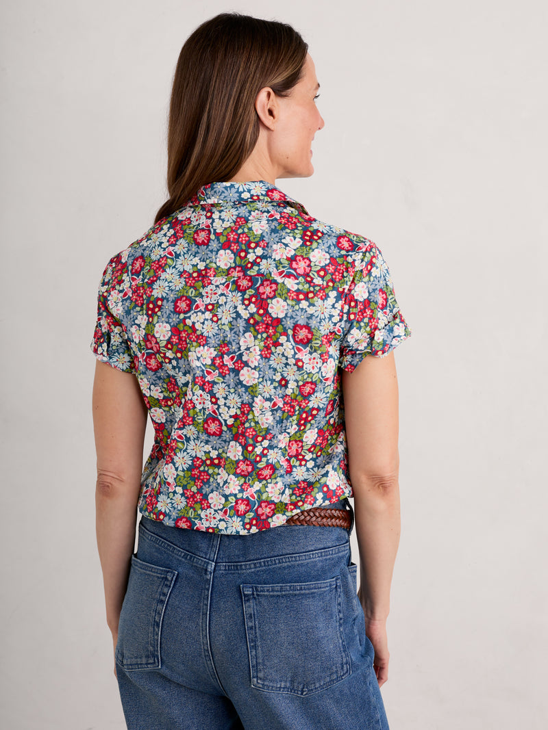 An image of a model wearing the Seasalt Mrs Treloar Short Sleeve Shirt in the colour Flowery Painting Light Squid.
