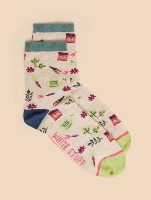 White Stuff Gardening Sock. A cream sock with a colourful design of multiple gardening tools all-over.