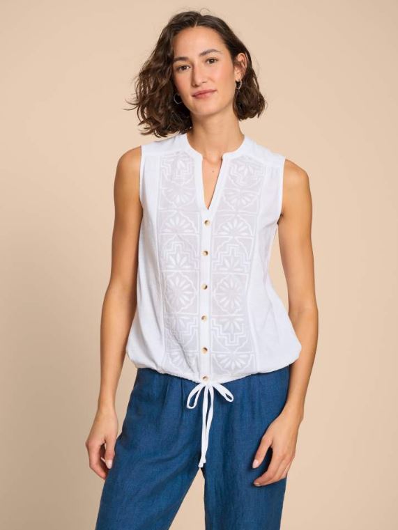 White Stuff Tulip Jersey Sleeveless Shirt. A button-up shirt with a tie hem and feminine intricate embroidery detail