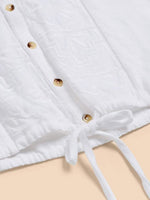 White Stuff Tulip Jersey Sleeveless Shirt. A button-up shirt with a tie hem and feminine intricate embroidery detail